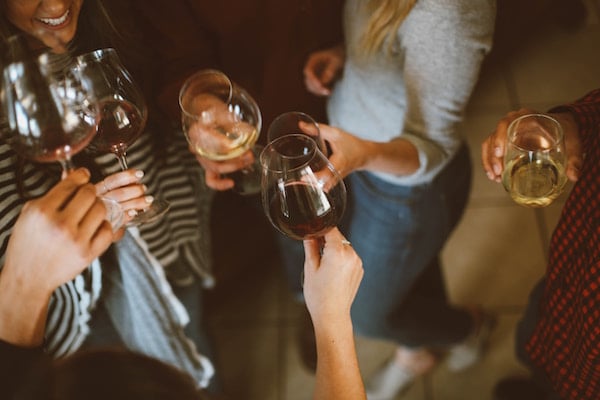 A group toasts wine glasses