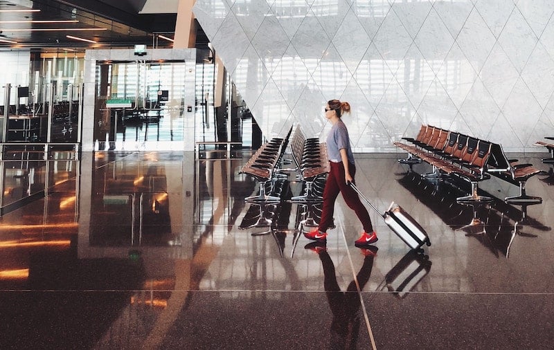 woman walks through airport