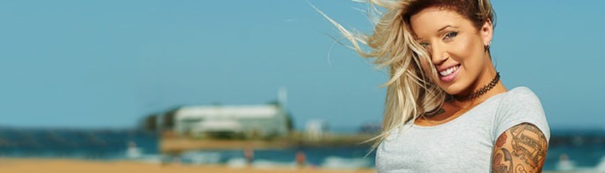 At the beach with piercings and tattoos