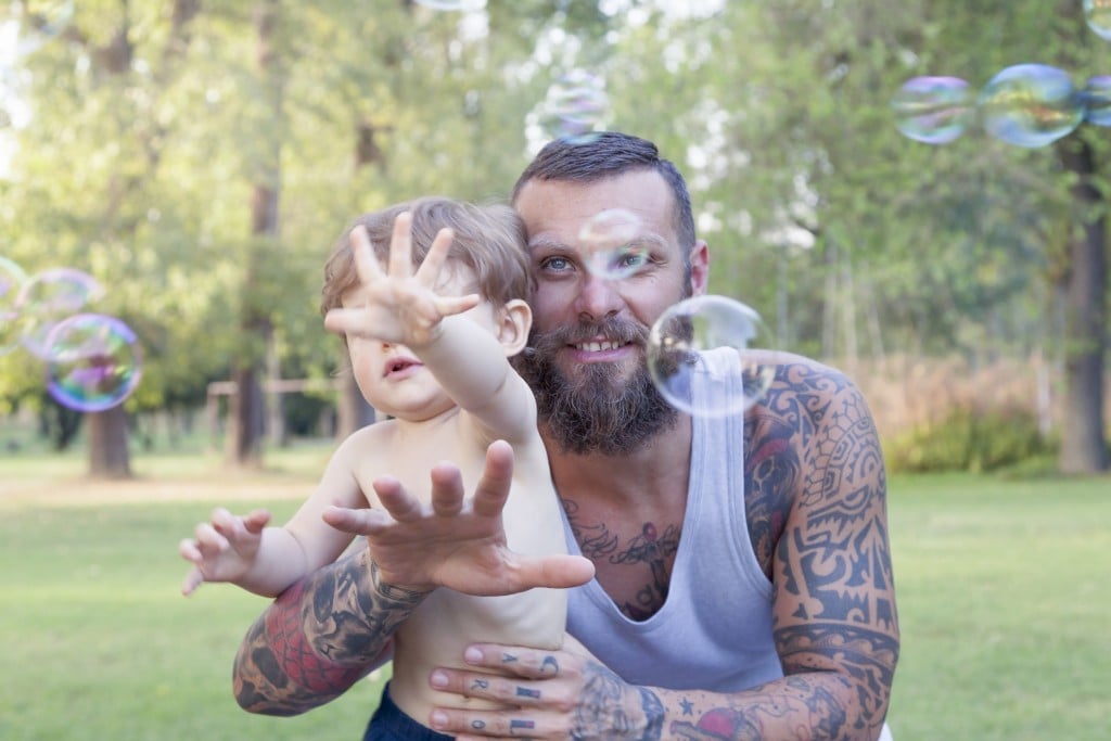 Dad with tattoos and his child
