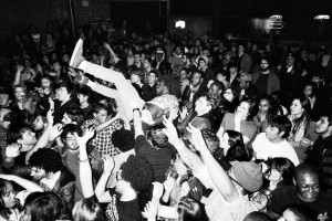 Crowd surfing over a mosh pit