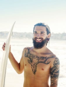 Surfer with chest tattoo and septum ring