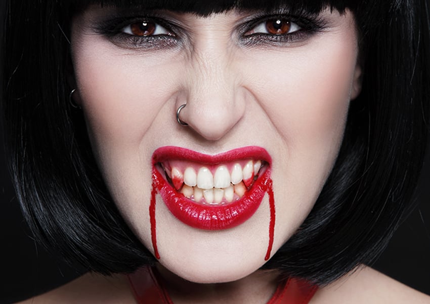 Woman in vampire makeup with nose piercing