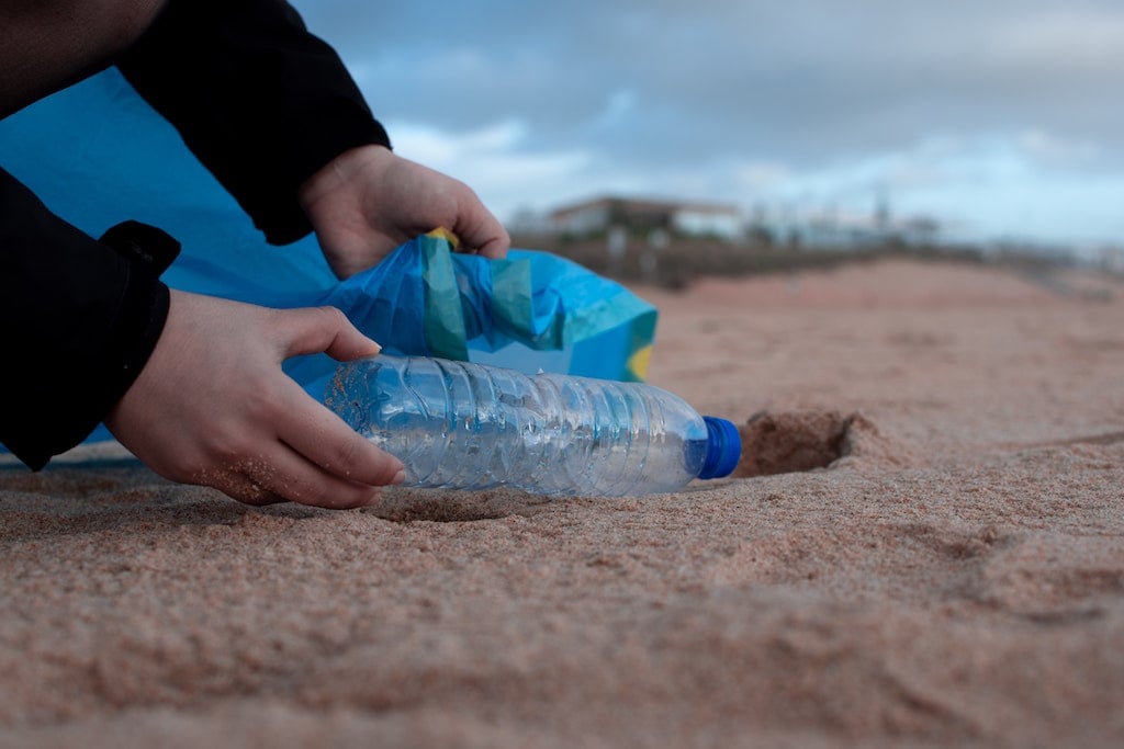 person picking up trash