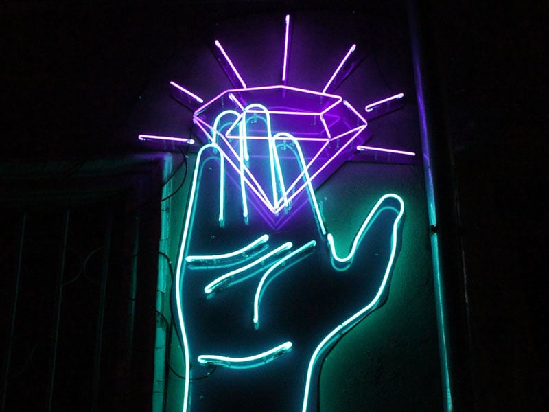 neon lighting with hand holding diamond