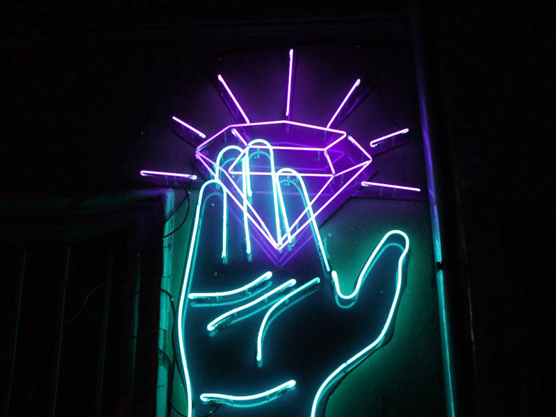 neon lighting with hand holding diamond