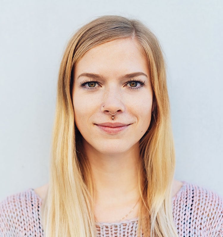 smiling woman with facial piercings