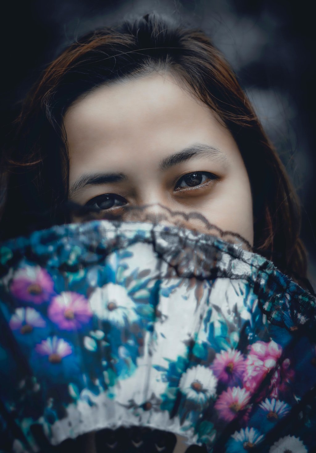 Woman Covering Face with Fan