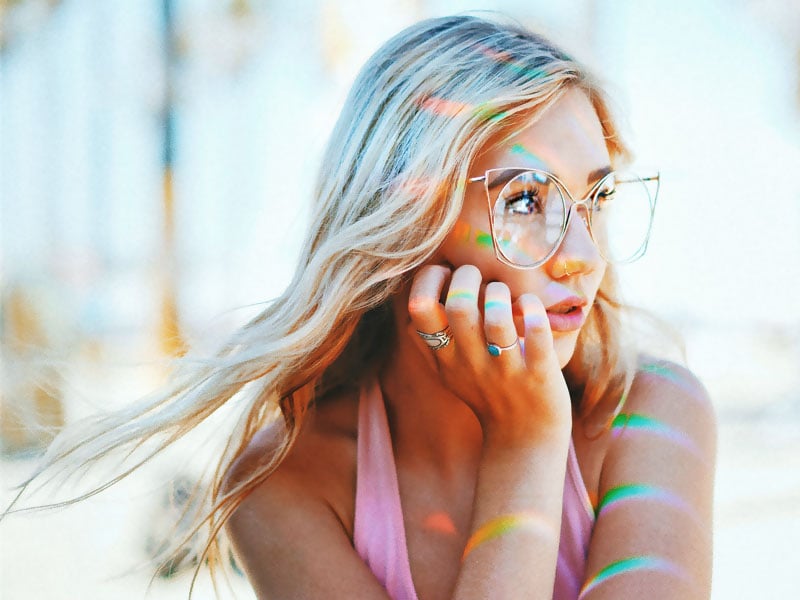 Woman with fashionable sunglasses and nose piercing