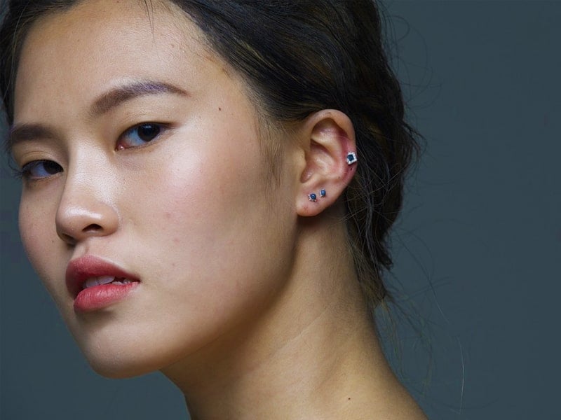 Woman with cartilage piercings