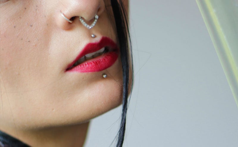 Woman with multiple facial piercings