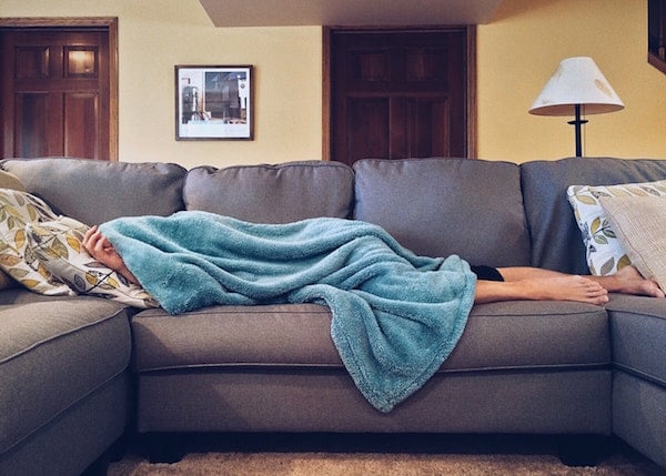 woman sick on couch