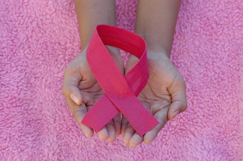 Woman Holding Breast Cancer Ribbon