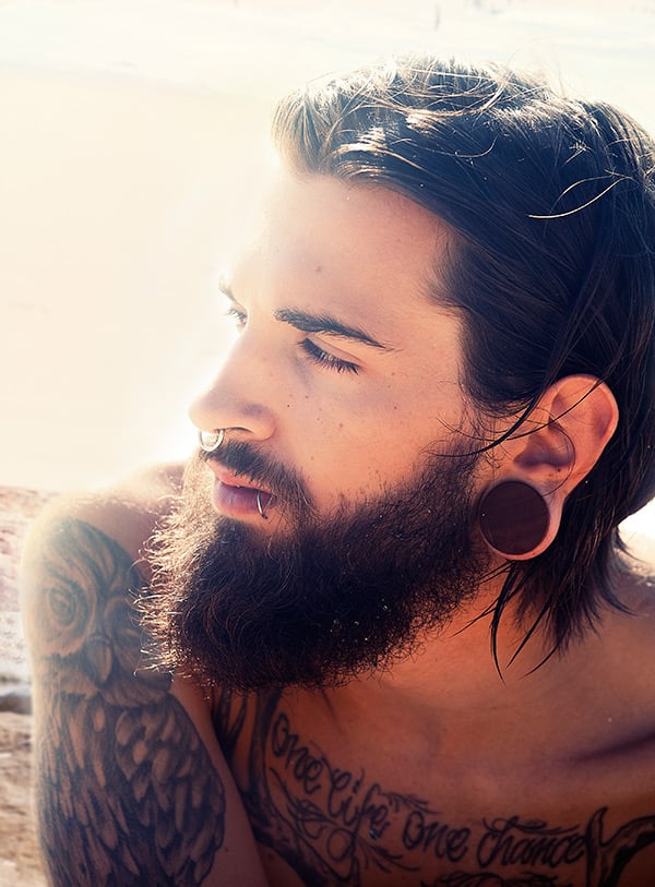 Man at the beach with stretched ears.