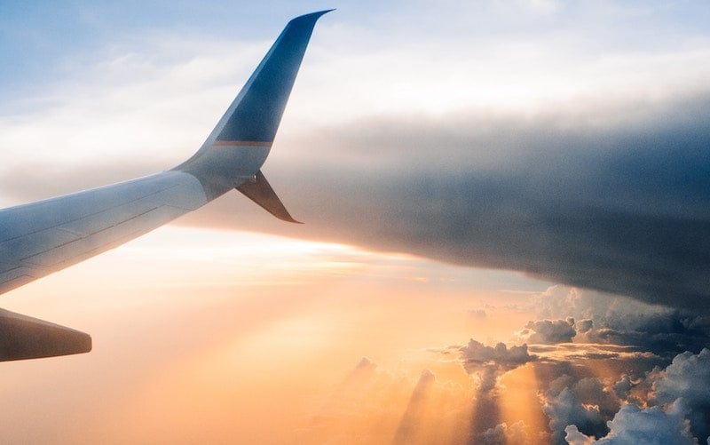 View from airplane window in the air at sunset