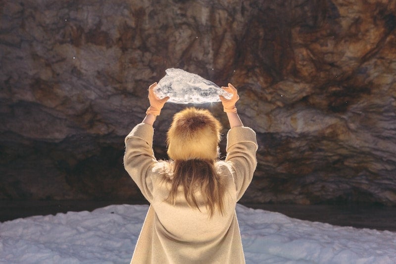 Girl Holding Melting Piece of Ice in Nature