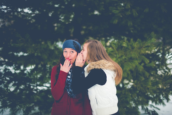 Two women whispering