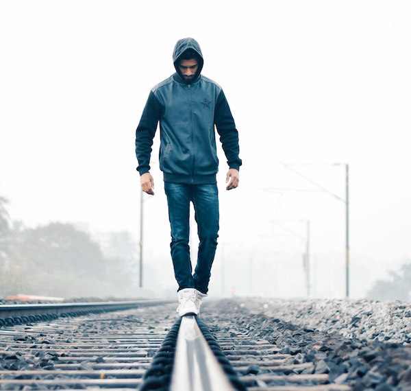 Guy Balancing on Train Tracks