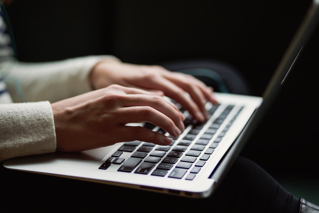 Person typing on keyboard