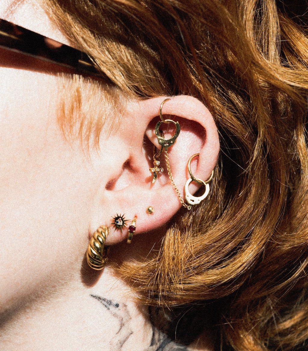 woman with ear full of piercings