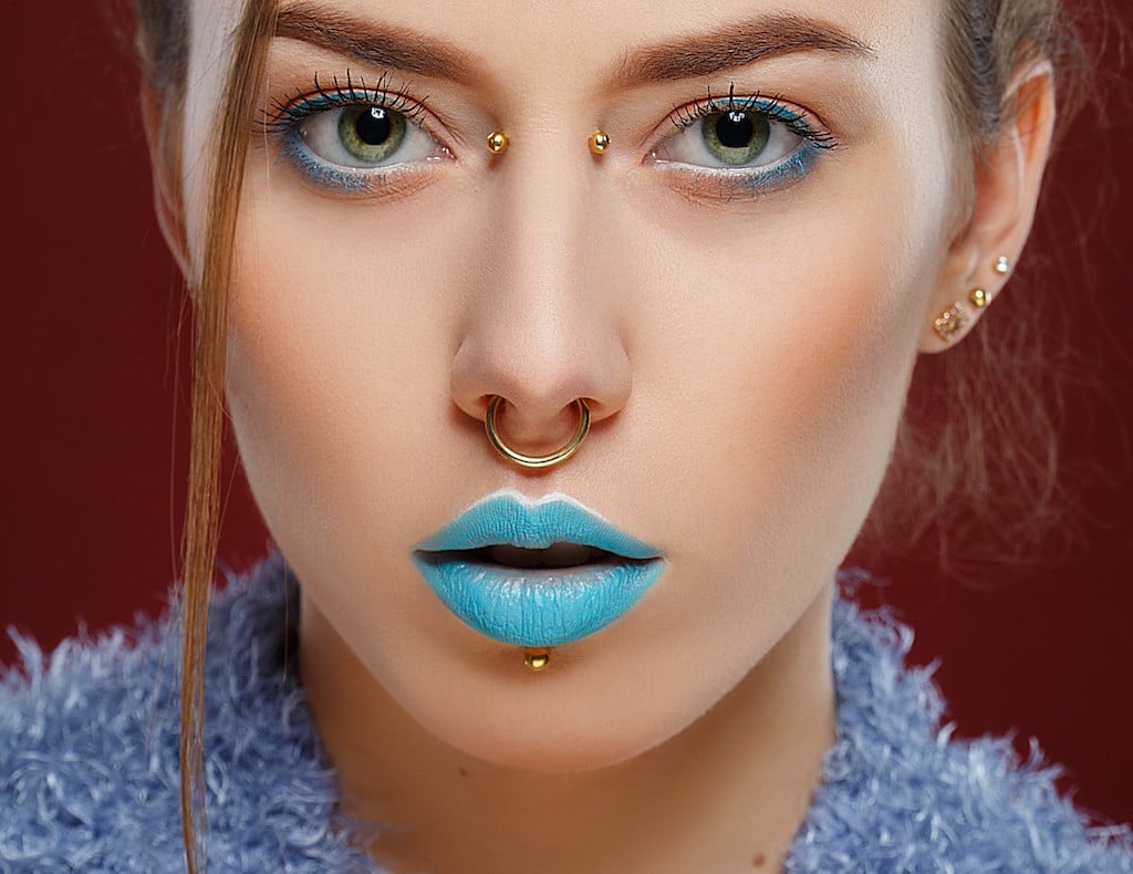 Woman with blue lipstick and a bridge piercing