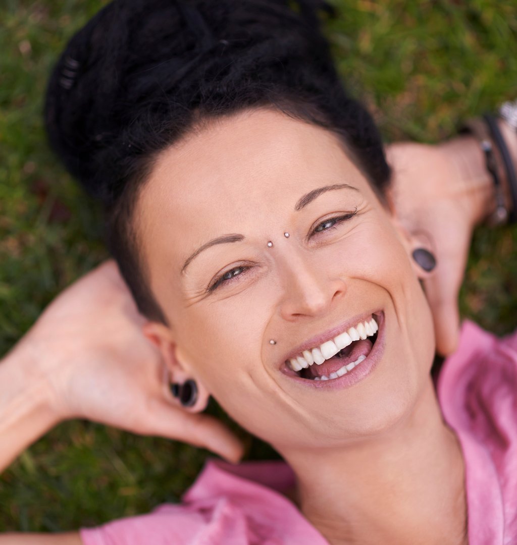 woman with stretched lobes and a bridge piercing