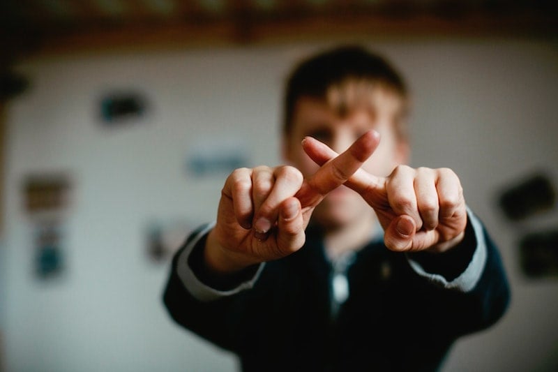 Person Making X With Fingers