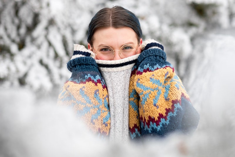 woman looking cozy in the snow