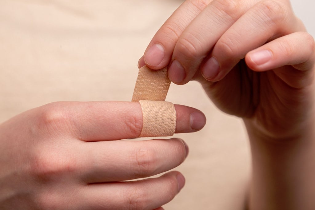 person putting on a bandaid