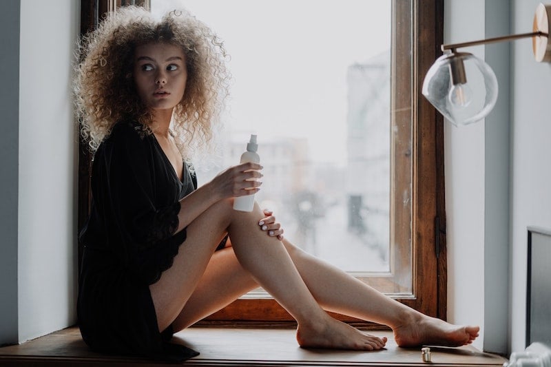 Woman Holds Spray Bottle