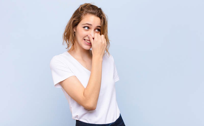 Woman plugging nose