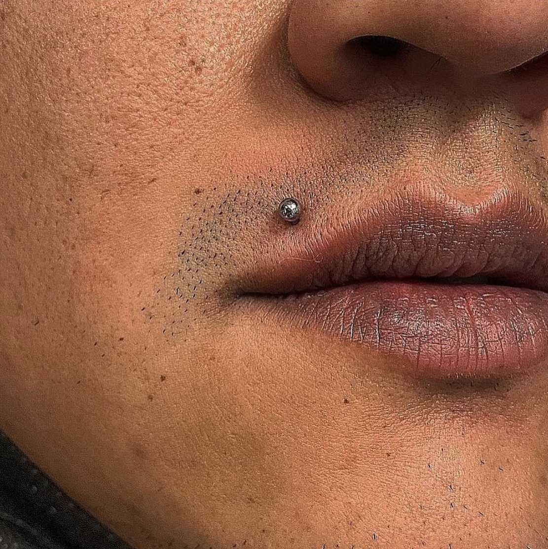 man with madonna piercing