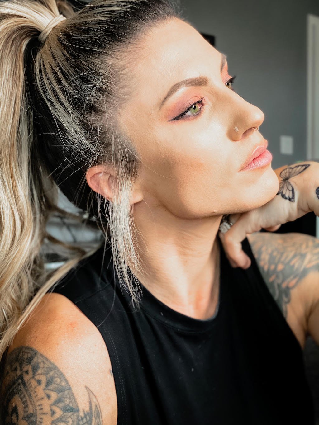 Woman with multiple tattoos and nose piercings
