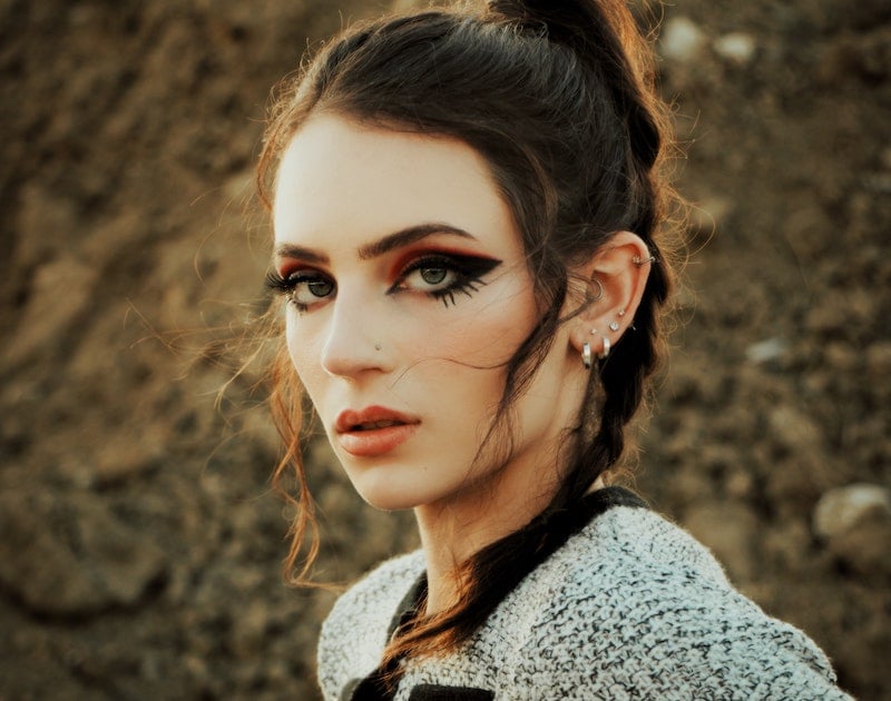 Woman with cool eyeliner and lots of ear piercings