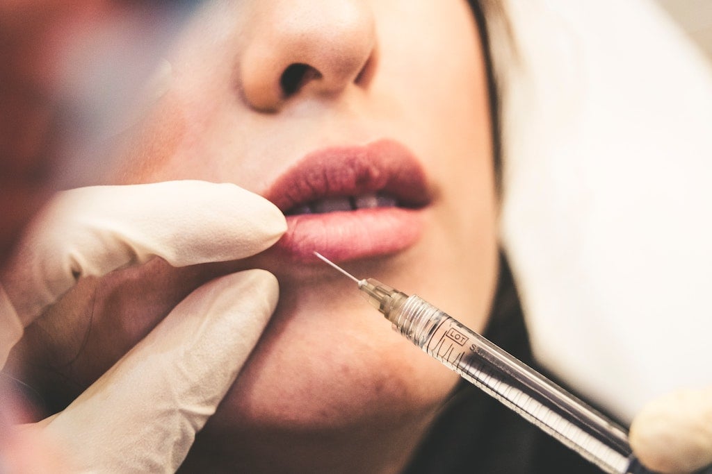 woman getting botox in lip