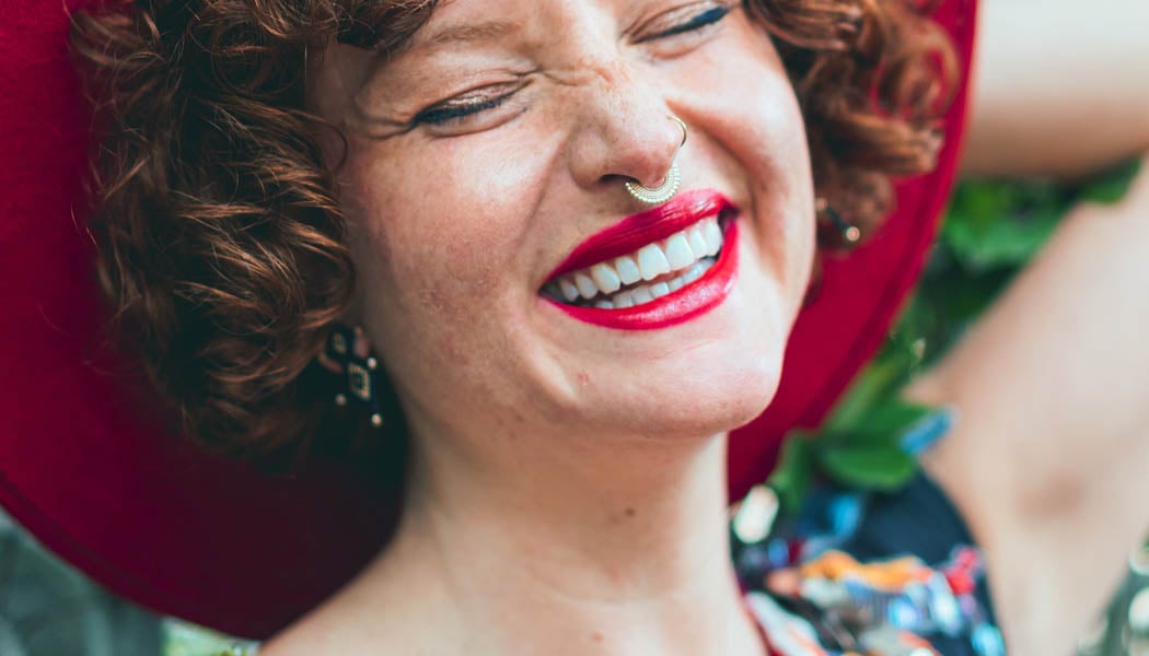 Smiling woman with nose piercings