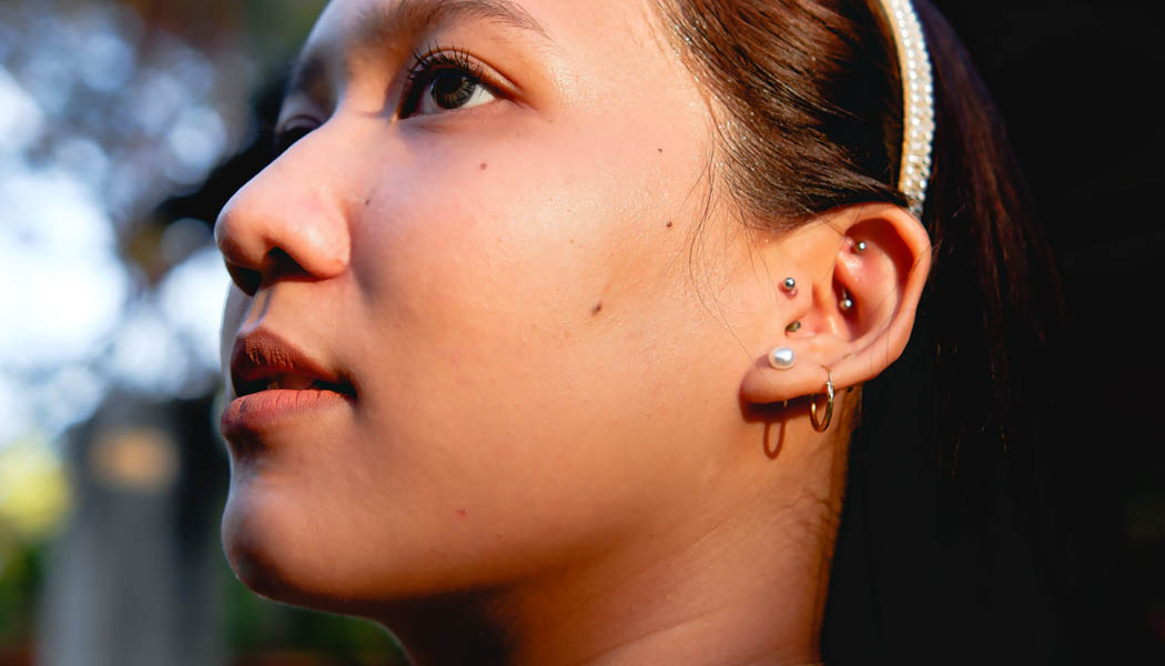 Asian woman with multiple ear piercings